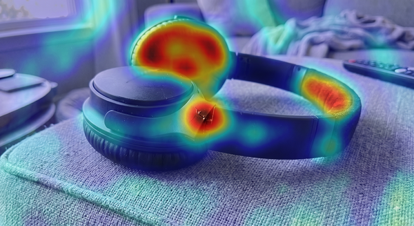 Forensic heatmap of the same cracked headphones photo, with the AI-edited region highlighted