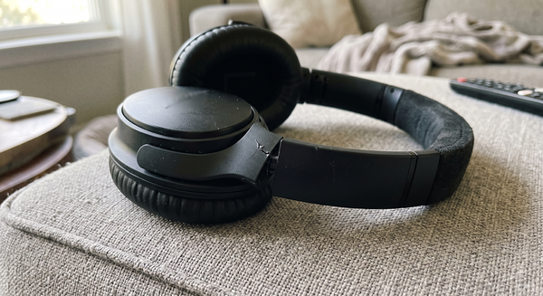 Black over-ear headphones on a sofa — the photo the customer submitted with their refund claim